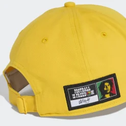 adidas Kopfbedeckungen|Kopfbedeckungen<· Jamaika 26 x Bob Marley Baseball Kappe Bold Gold / Black